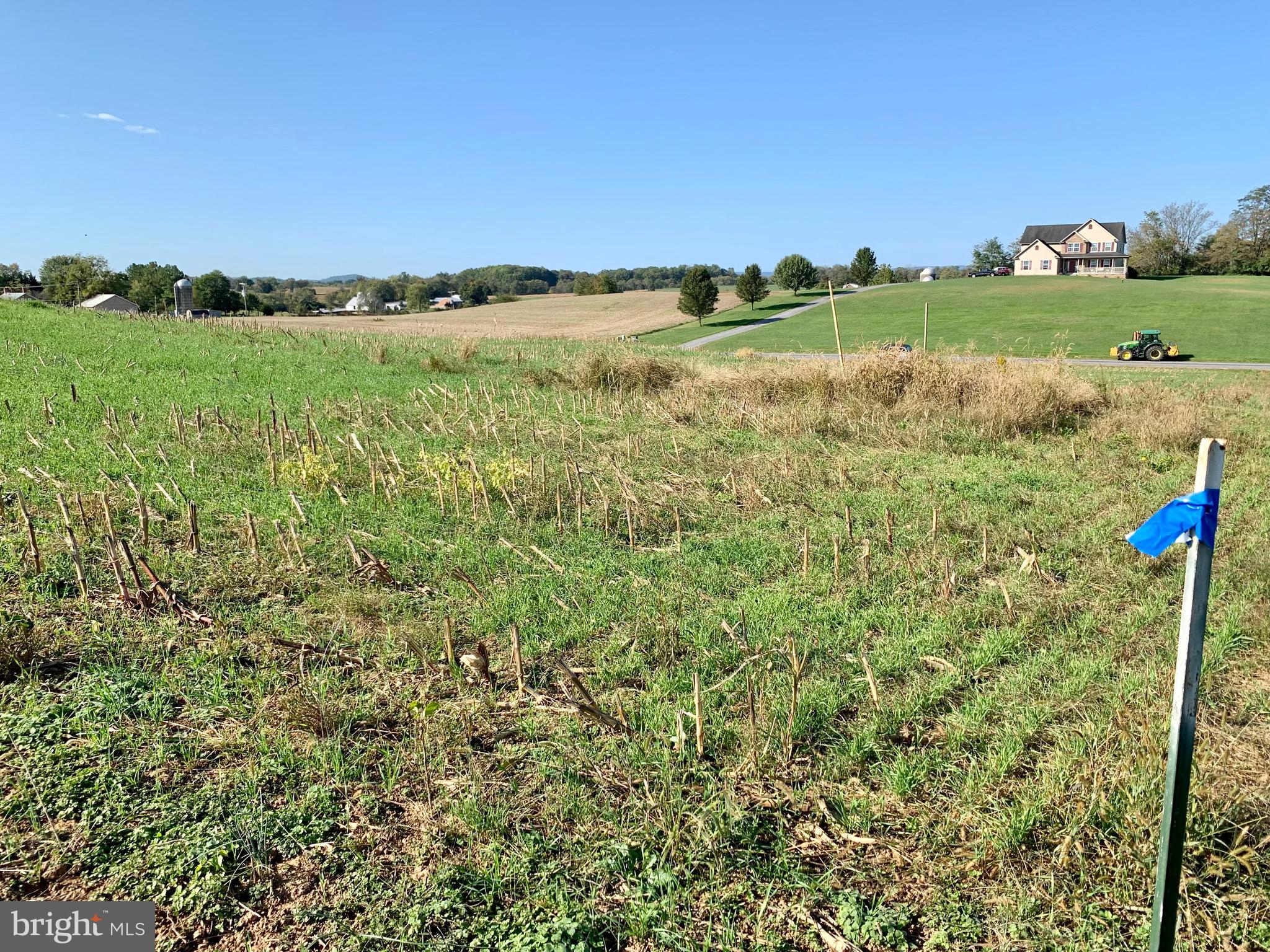 SW view of Lot from NE corner-Well in grassy area