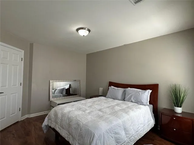a bedroom with a bed and a potted plant