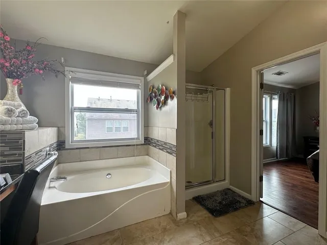 a bathroom with a bathtub a toilet and a shower