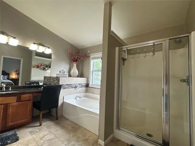 a bathroom with a bathtub a sink and a shower