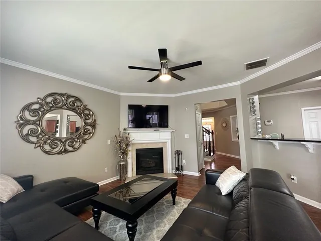a living room with furniture a table and a fireplace