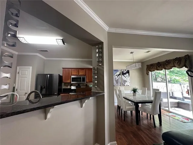 a view of a a dining room with furniture window and outside view