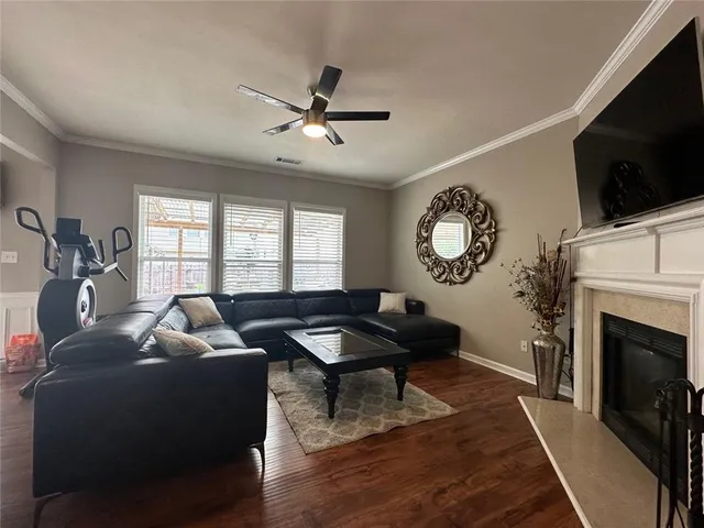 a living room with furniture a fireplace and a flat screen tv