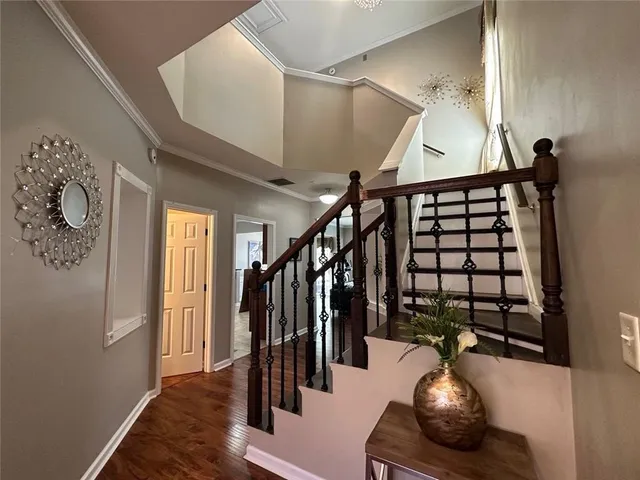 a living room with wooden floor and stairs