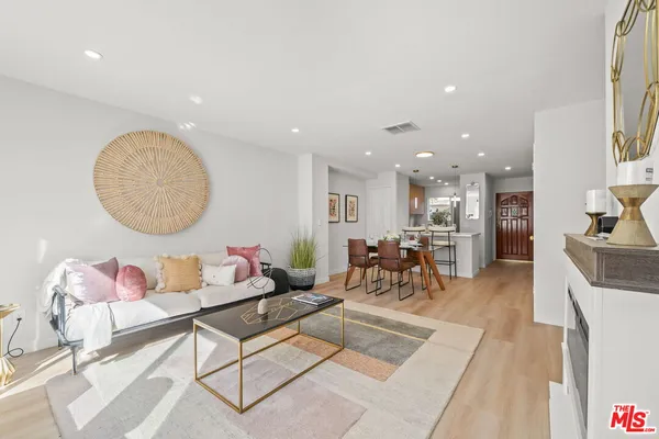a living room with furniture and a mirror