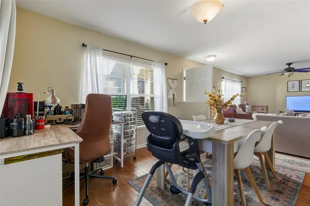 a view of a workspace with furniture and a window