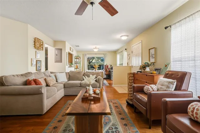 a living room with furniture or couch and a ceiling fan