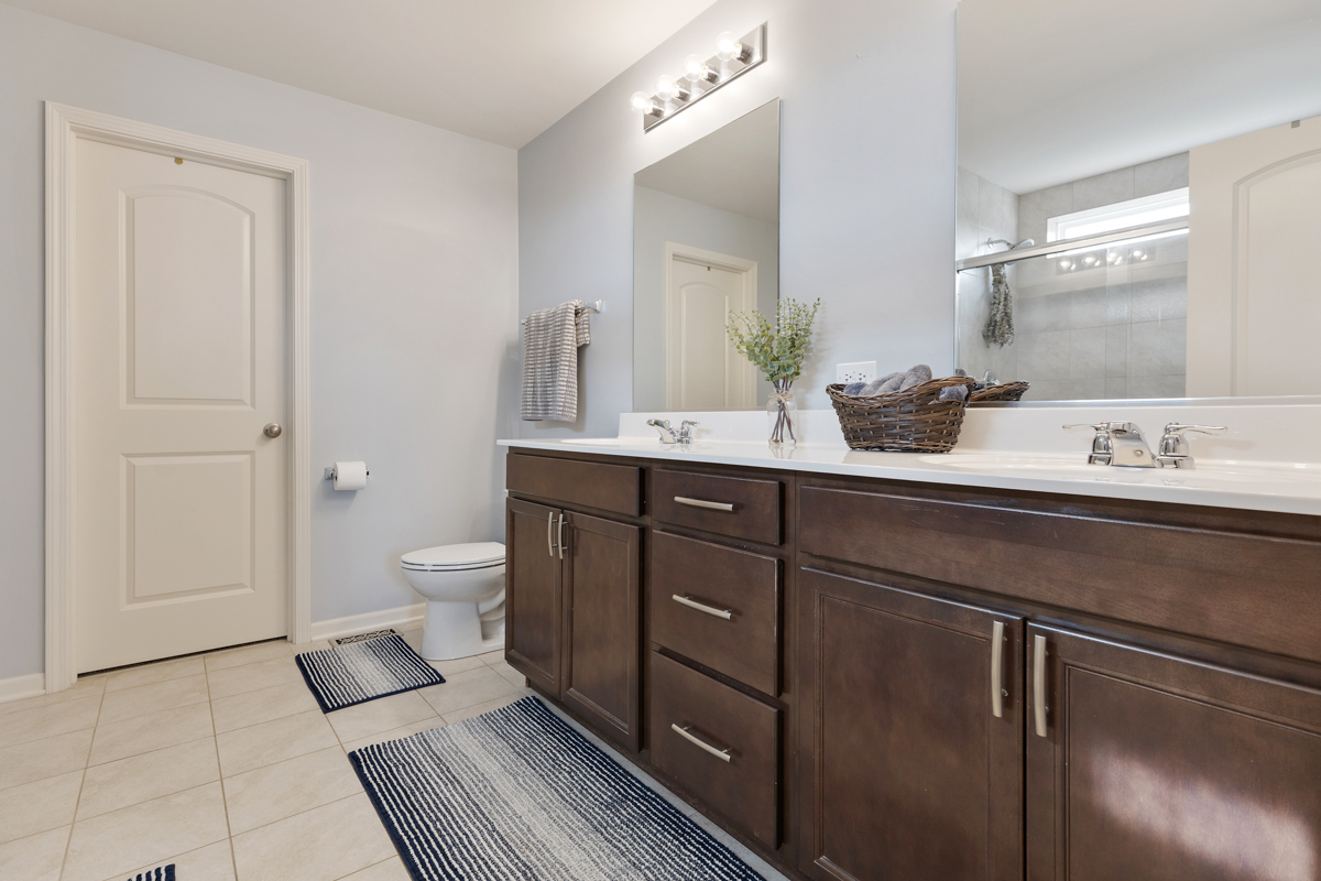 3827 Trillium Trail Elgin, IL 60124 - Photo 12 of 29 a spacious bathroom with a toilet sink and mirror
