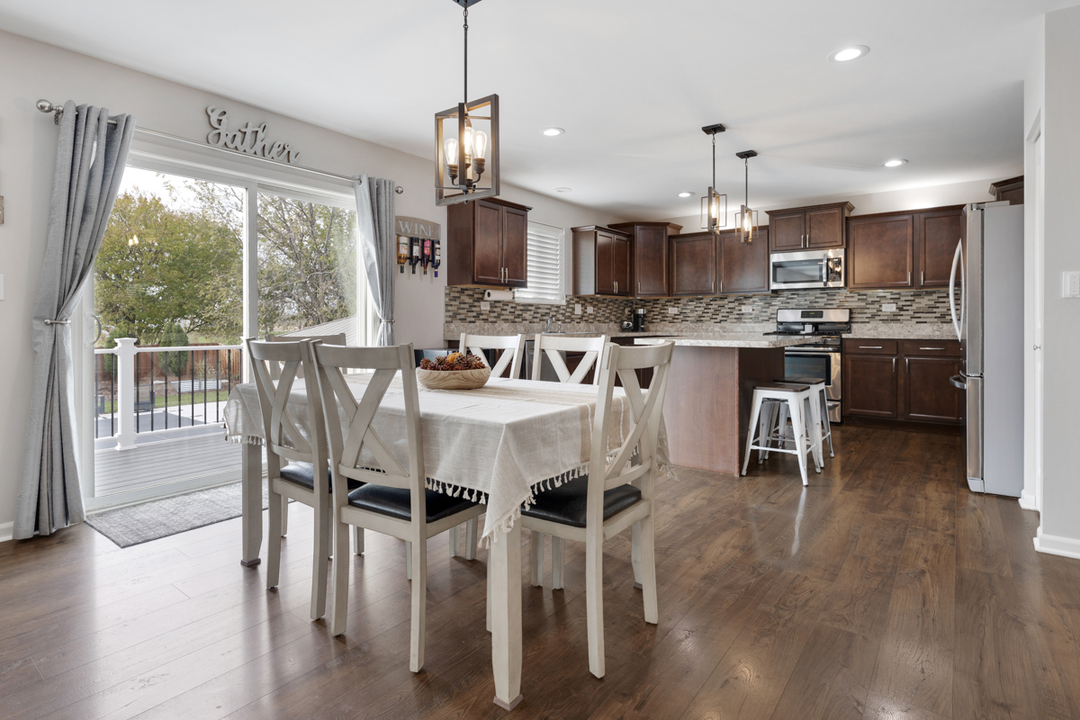 3827 Trillium Trail Elgin, IL 60124 - Photo 4 of 29 a view of a dining room and livingroom with furniture wooden floor a chandelier