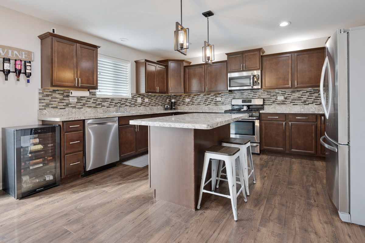3827 Trillium Trail Elgin, IL 60124 - Photo 5 of 29 a kitchen with stainless steel appliances granite countertop hardwood floor sink stove and refrigerator