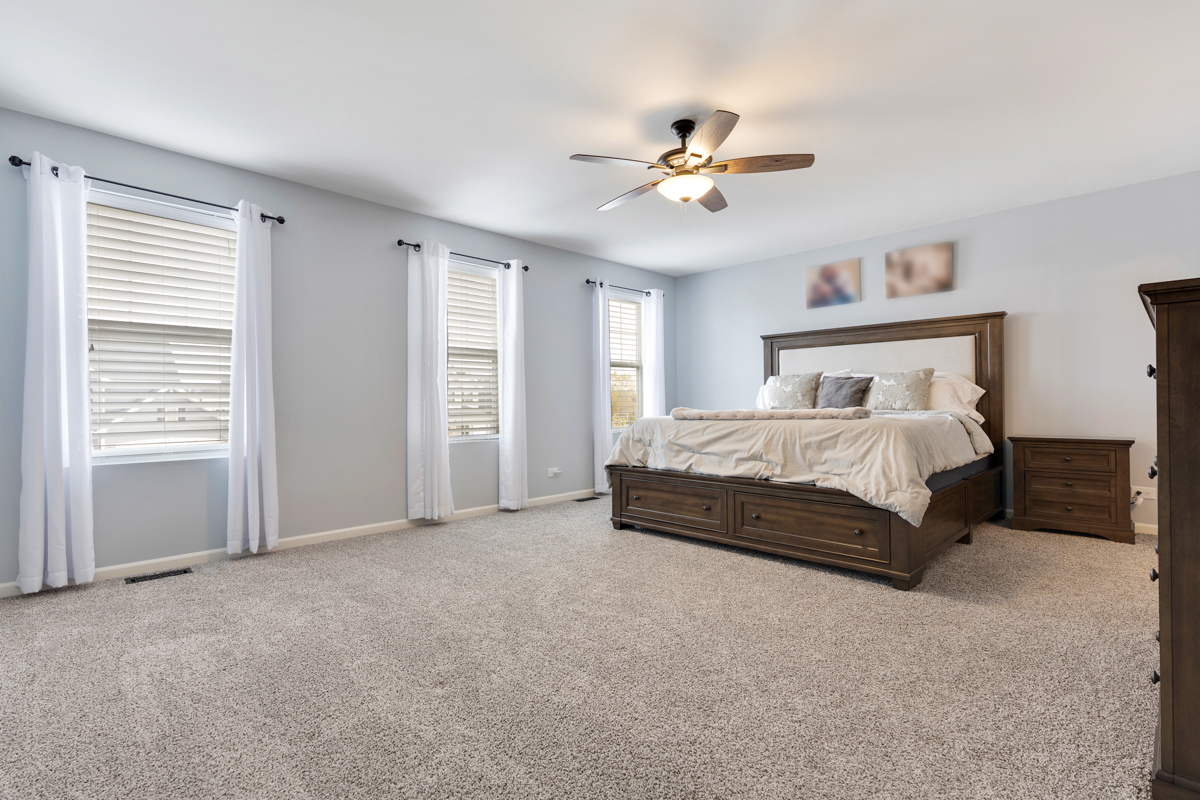 3827 Trillium Trail Elgin, IL 60124 - Photo 10 of 29 a spacious bedroom with a bed and ceiling fan