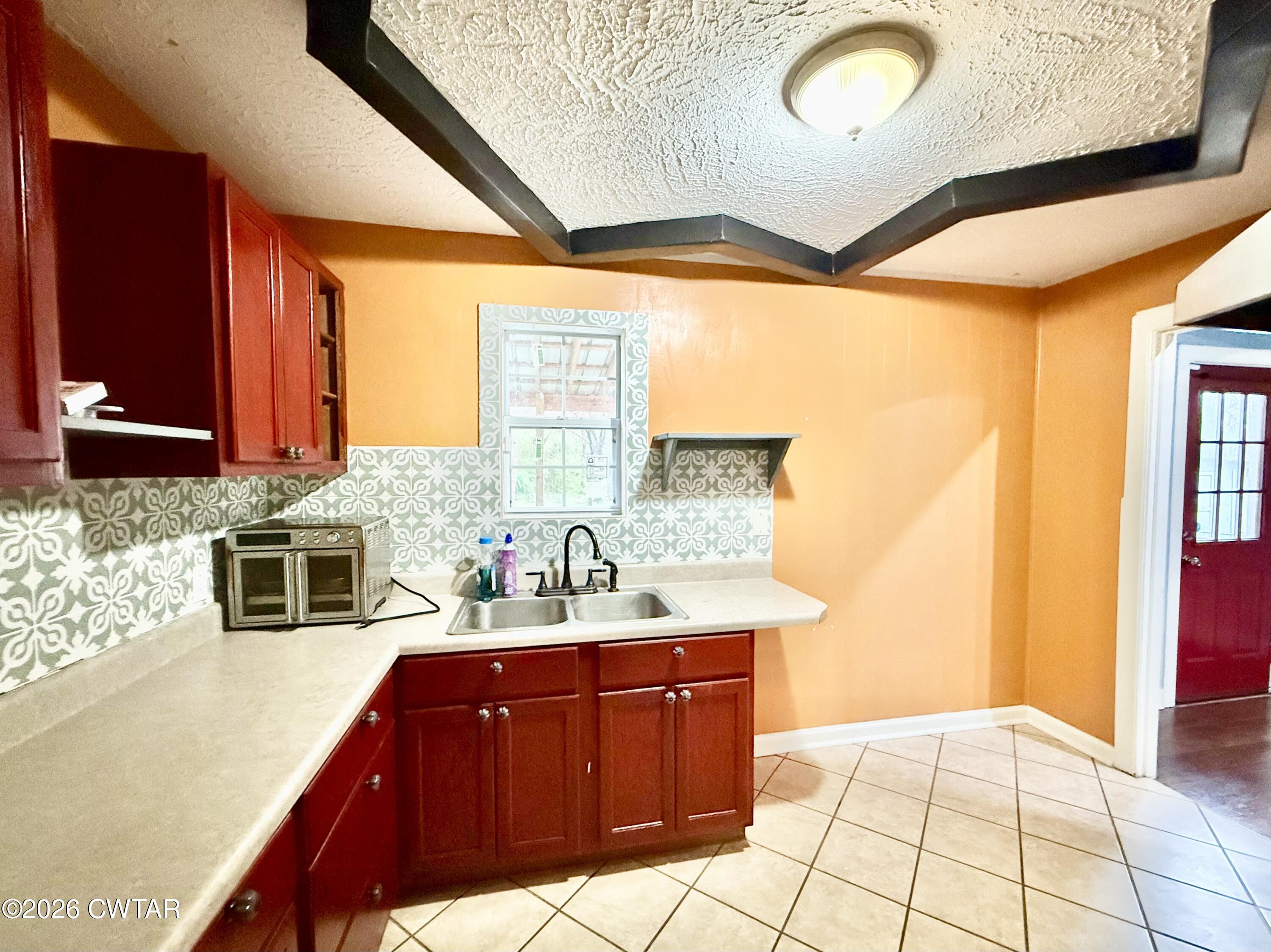 344 Phillips Street Jackson, TN 38301 - Photo 11 of 33 a bathroom with a sink a vanity and a mirror