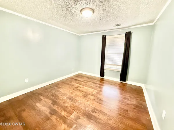 a view of a big room with closet and wooden floor