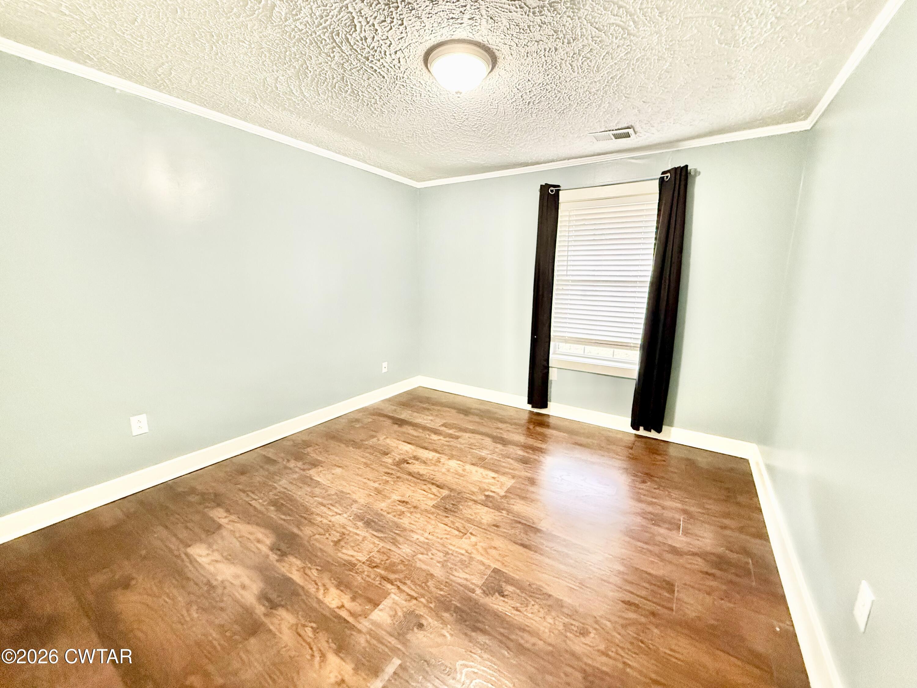 344 Phillips Street Jackson, TN 38301 - Photo 15 of 33 a view of a big room with closet and wooden floor