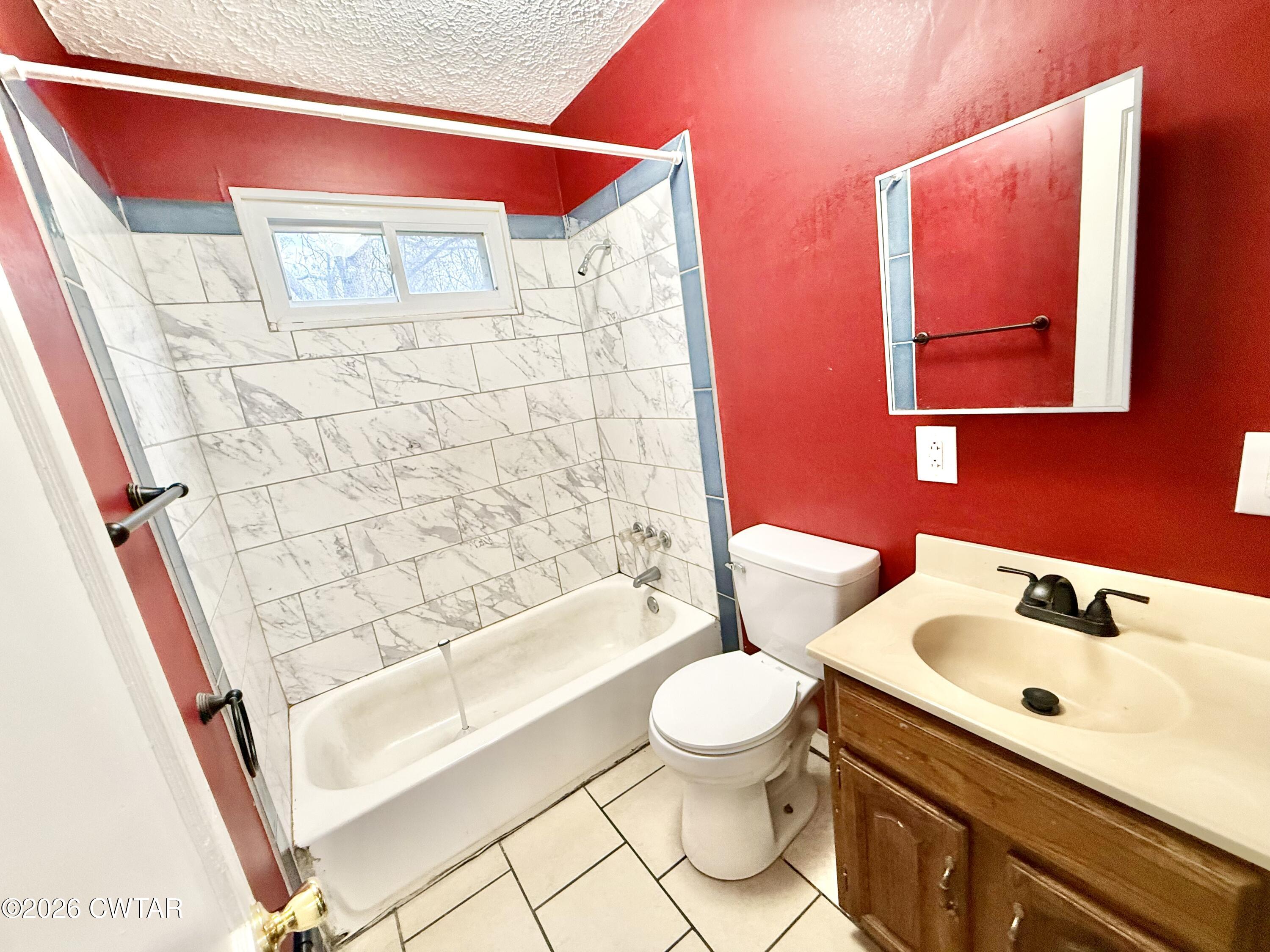 344 Phillips Street Jackson, TN 38301 - Photo 17 of 33 a bathroom with a sink toilet and shower