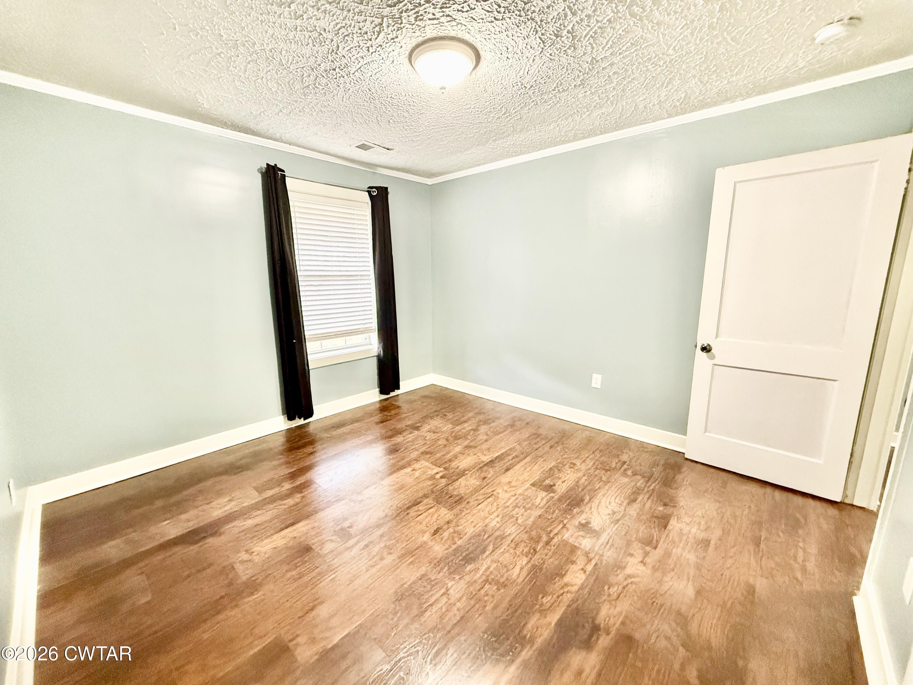 344 Phillips Street Jackson, TN 38301 - Photo 19 of 33 a view of empty room with wooden floor