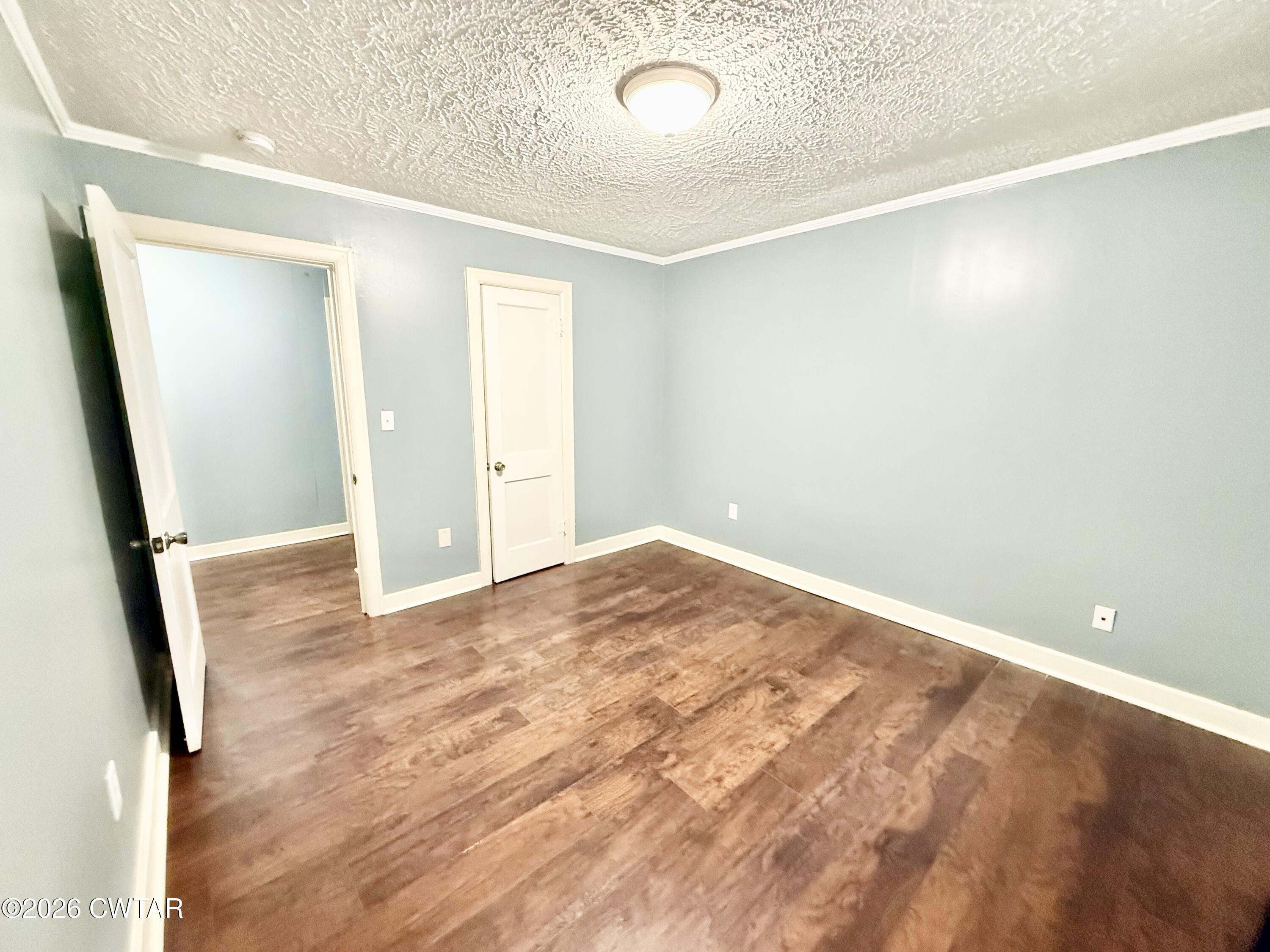 344 Phillips Street Jackson, TN 38301 - Photo 20 of 33 an empty room with wooden floor and entrance