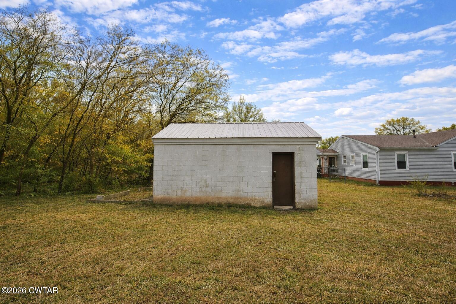 344 Phillips Street Jackson, TN 38301 - Photo 30 of 33 a view of a house with a yard