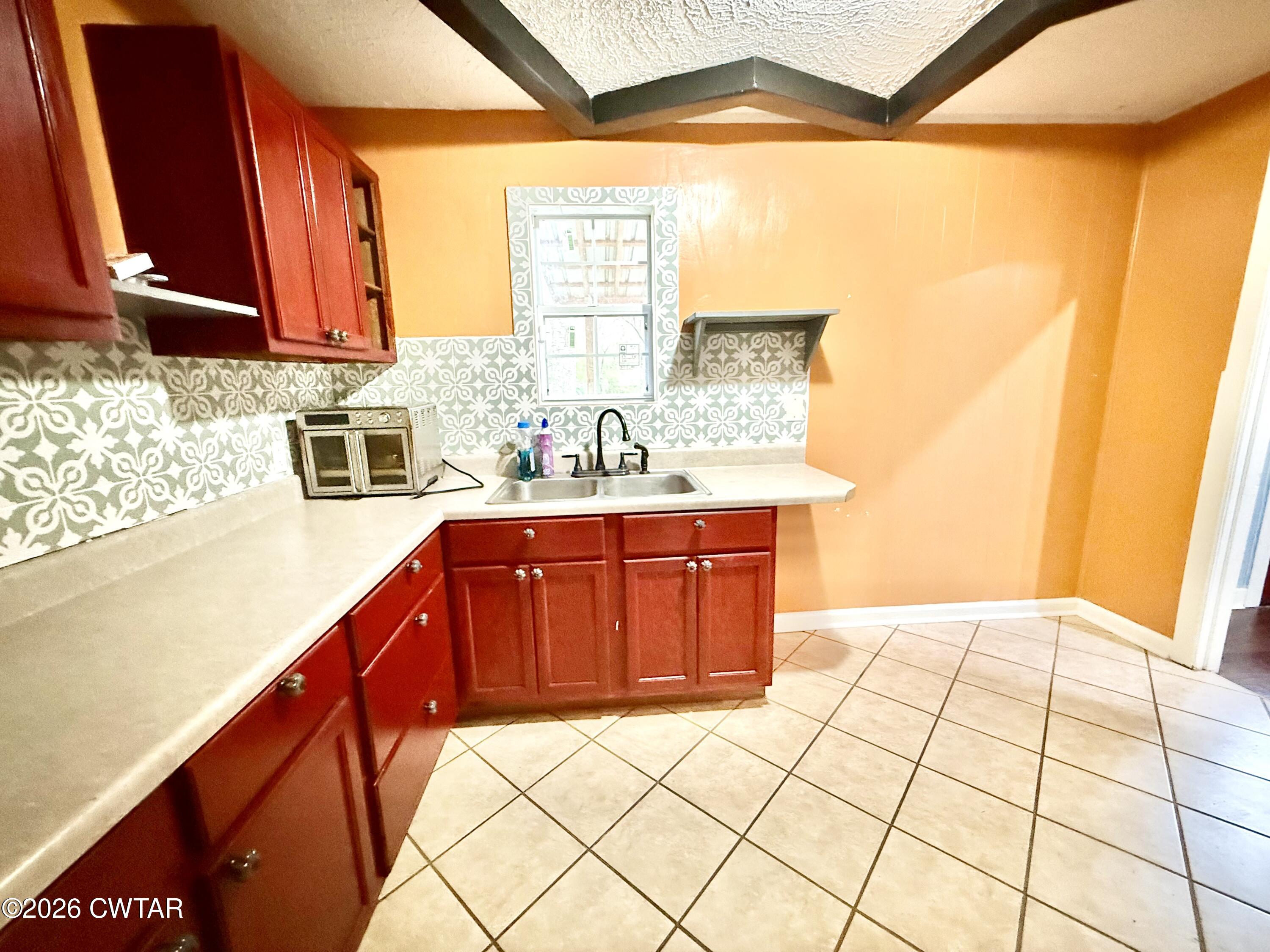 344 Phillips Street Jackson, TN 38301 - Photo 3 of 33 a bathroom with a sink a vanity and a mirror