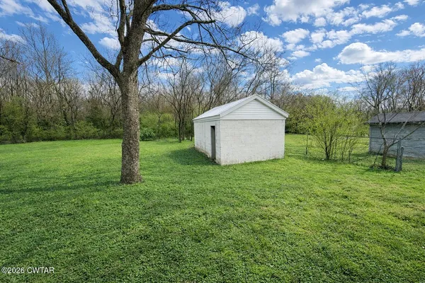 a view of a backyard with large trees