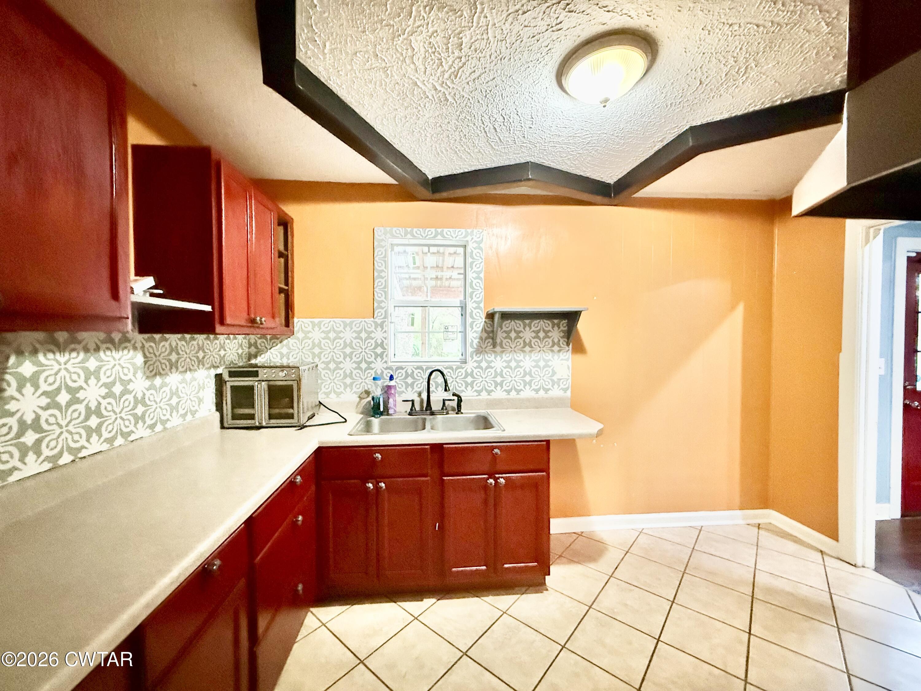 344 Phillips Street Jackson, TN 38301 - Photo 9 of 33 a kitchen with a sink a stove and a refrigerator