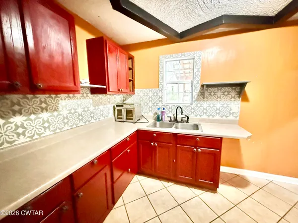 a kitchen with stainless steel appliances a sink and cabinets