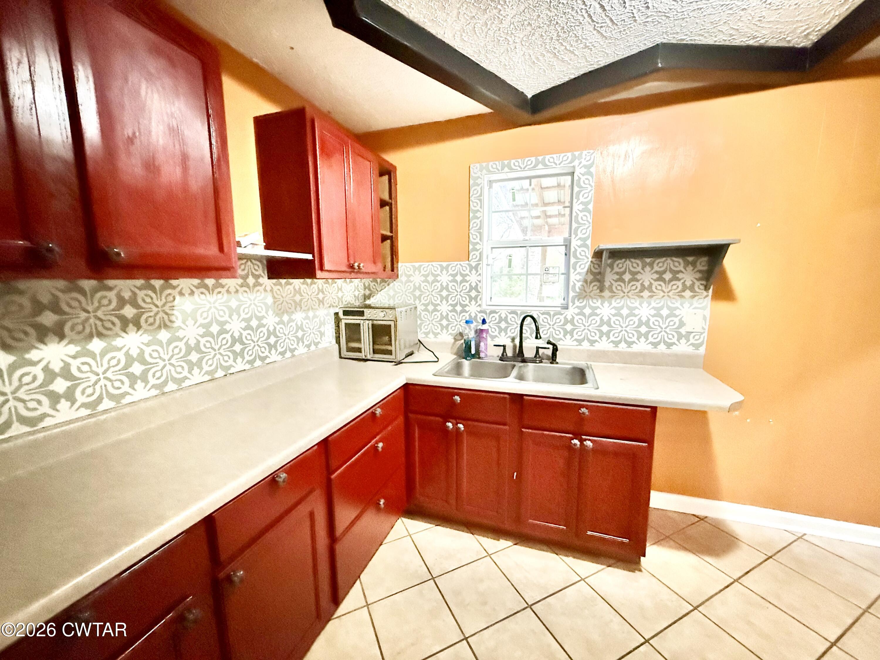 344 Phillips Street Jackson, TN 38301 - Photo 10 of 33 a kitchen with stainless steel appliances a sink and cabinets