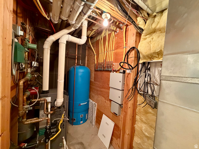 1133 Paris Canyon Road Paris, ID 83261 - Photo 71 of 75 Utility space featuring a water heater, furnace, extensive copper and PVC piping, electrical panels, and exposed wood framing