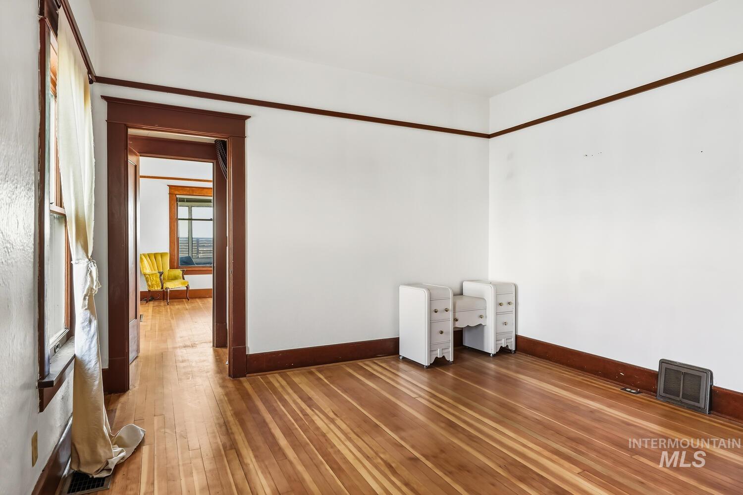 22573 Travis Road Wilder, ID 83676 - Photo 16 of 30 Spare room with baseboards and wood-type flooring