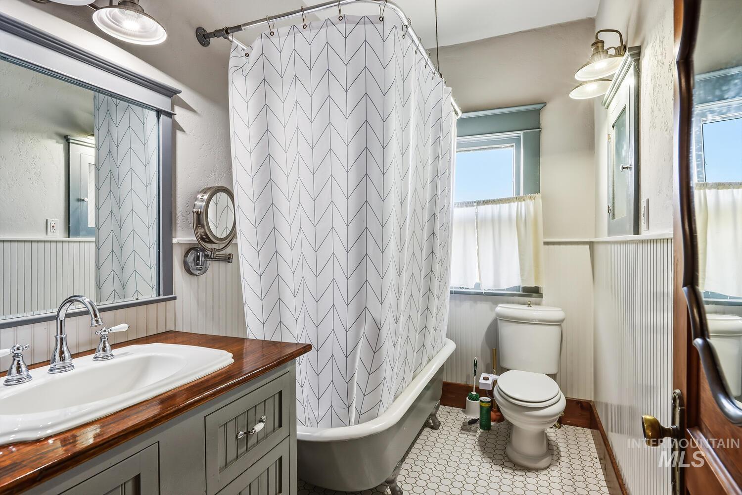 22573 Travis Road Wilder, ID 83676 - Photo 17 of 30 Bathroom featuring vanity and a combined bath / shower with freestanding tub