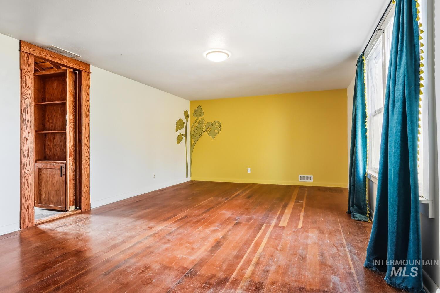 22573 Travis Road Wilder, ID 83676 - Photo 21 of 30 Unfurnished room with hardwood / wood-style flooring and baseboards