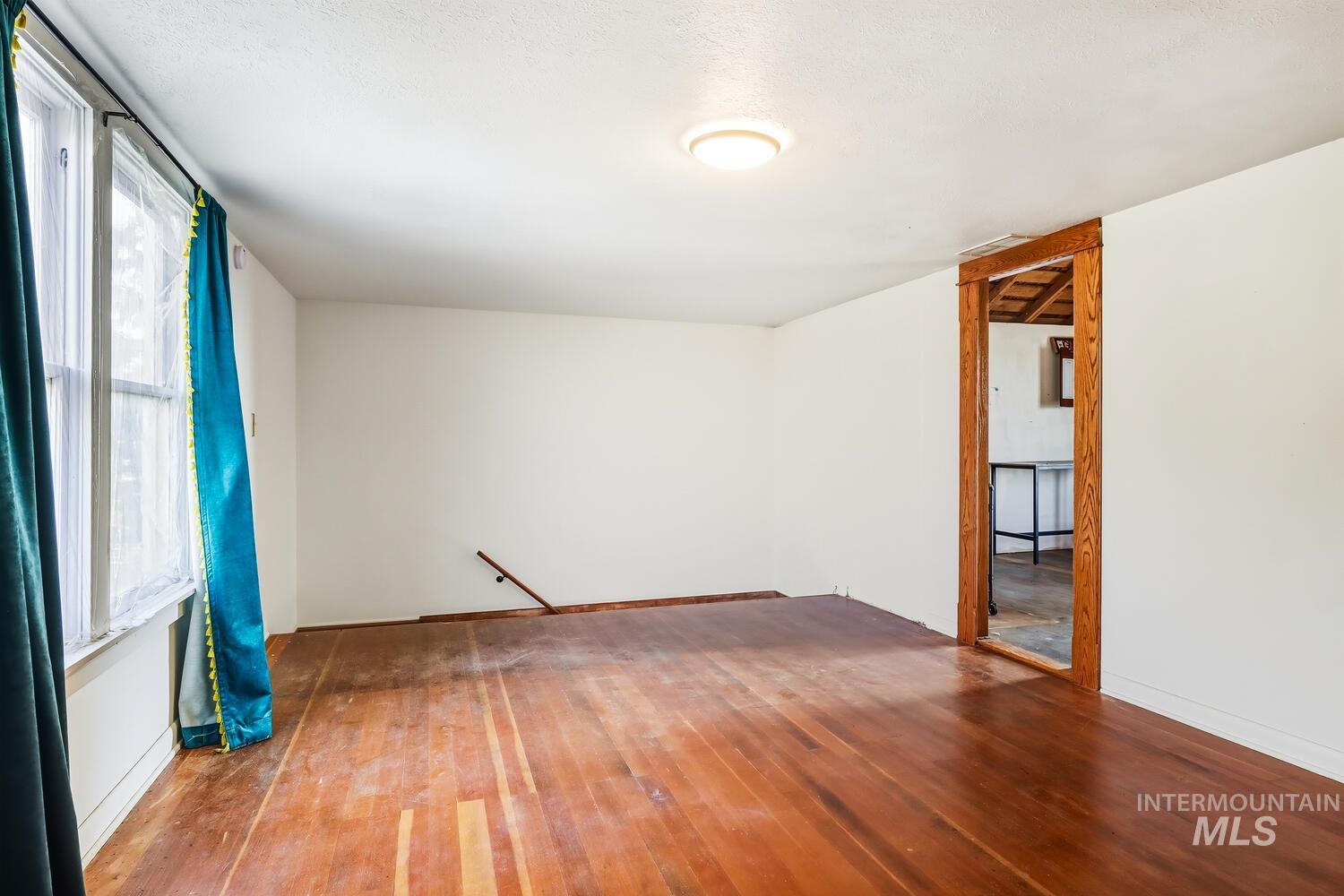22573 Travis Road Wilder, ID 83676 - Photo 22 of 30 Unfurnished room featuring wood-type flooring