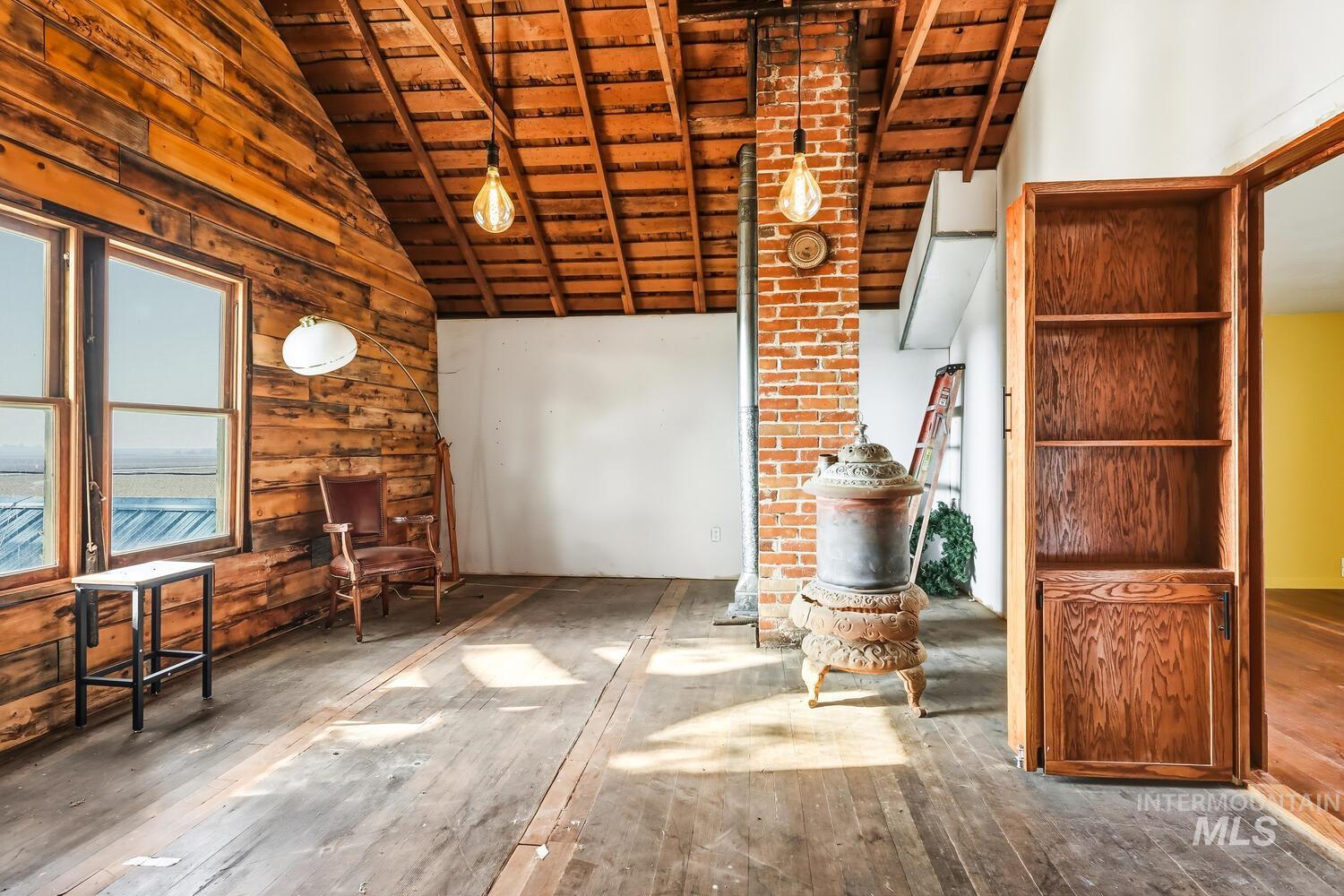 22573 Travis Road Wilder, ID 83676 - Photo 23 of 30 Unfurnished living room featuring hardwood / wood-style flooring and a high wooden beamed ceiling