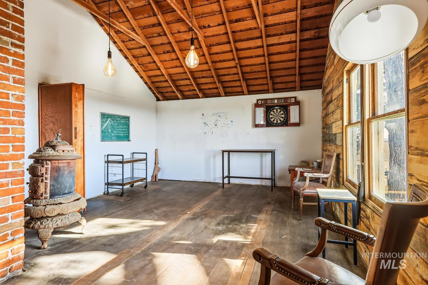 22573 Travis Road Wilder, ID 83676 - Photo 24 of 30 Sitting room with a high wood beamed ceiling and wood-type flooring