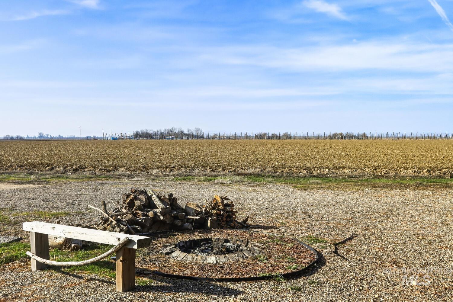 22573 Travis Road Wilder, ID 83676 - Photo 26 of 30 View of yard with agricultural area, a view of rural / pastoral area, and an outdoor fire pit