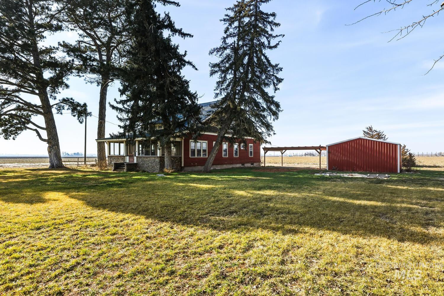 22573 Travis Road Wilder, ID 83676 - Photo 30 of 30 View of grassy yard featuring an outdoor structure and an outbuilding