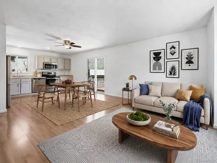 a living room with furniture and wooden floor