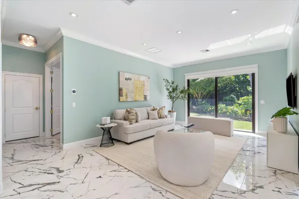 a living room with furniture and a potted plant