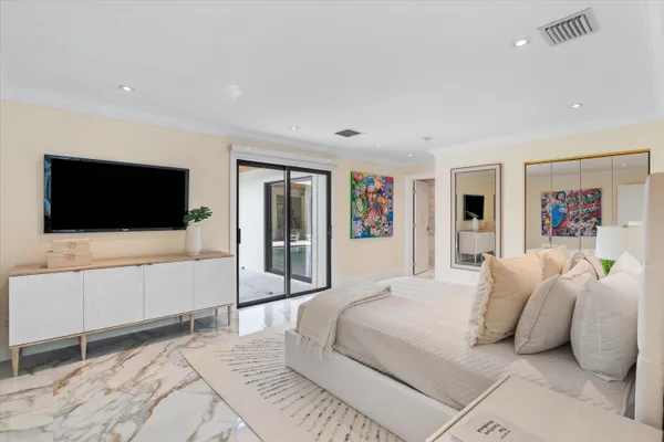 a bedroom with a large bed and a couch