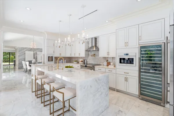 a spacious kitchen with stainless steel appliances granite countertop a sink a stove and a refrigerator