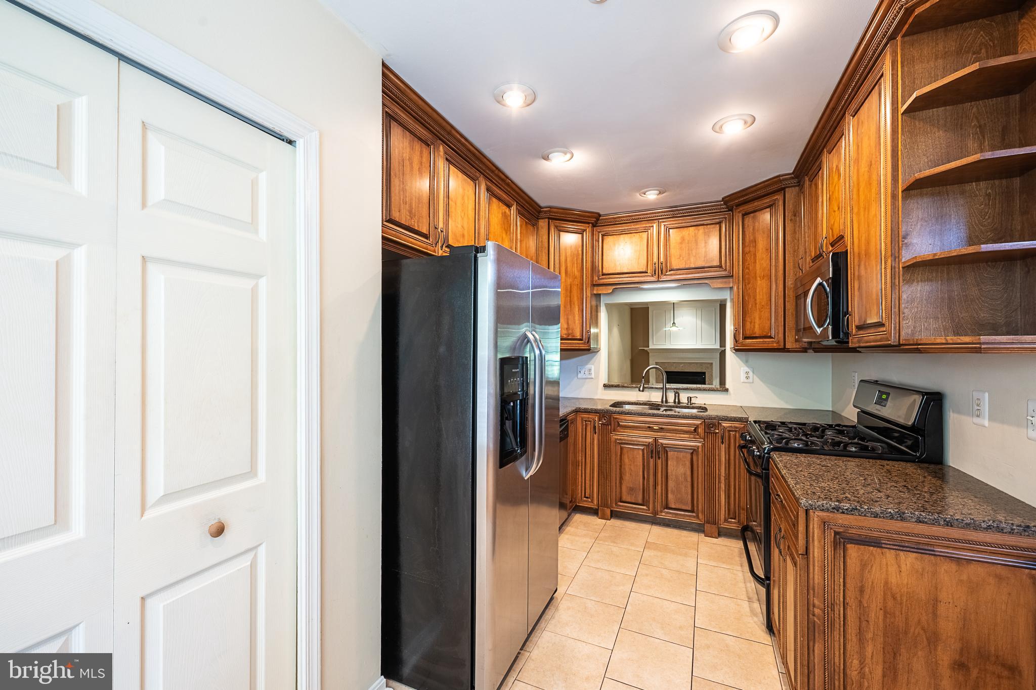 5920 Terrapin Place Alexandria, VA 22310 - Photo 11 of 67 a kitchen with stainless steel appliances granite countertop a refrigerator a stove and a sink