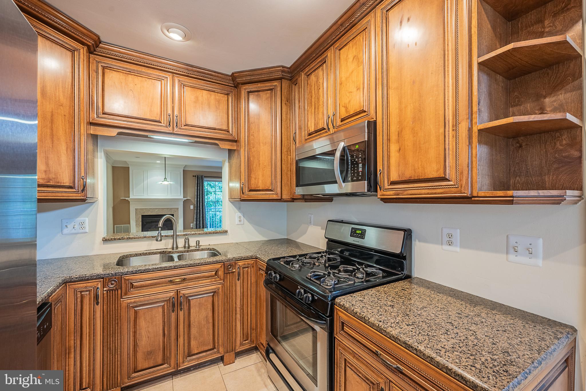 5920 Terrapin Place Alexandria, VA 22310 - Photo 13 of 67 a kitchen with stainless steel appliances granite countertop a stove a sink and a microwave