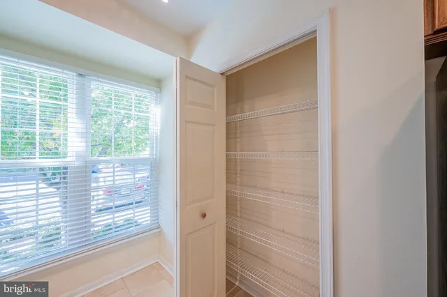 an empty room with wooden floor fireplace and windows