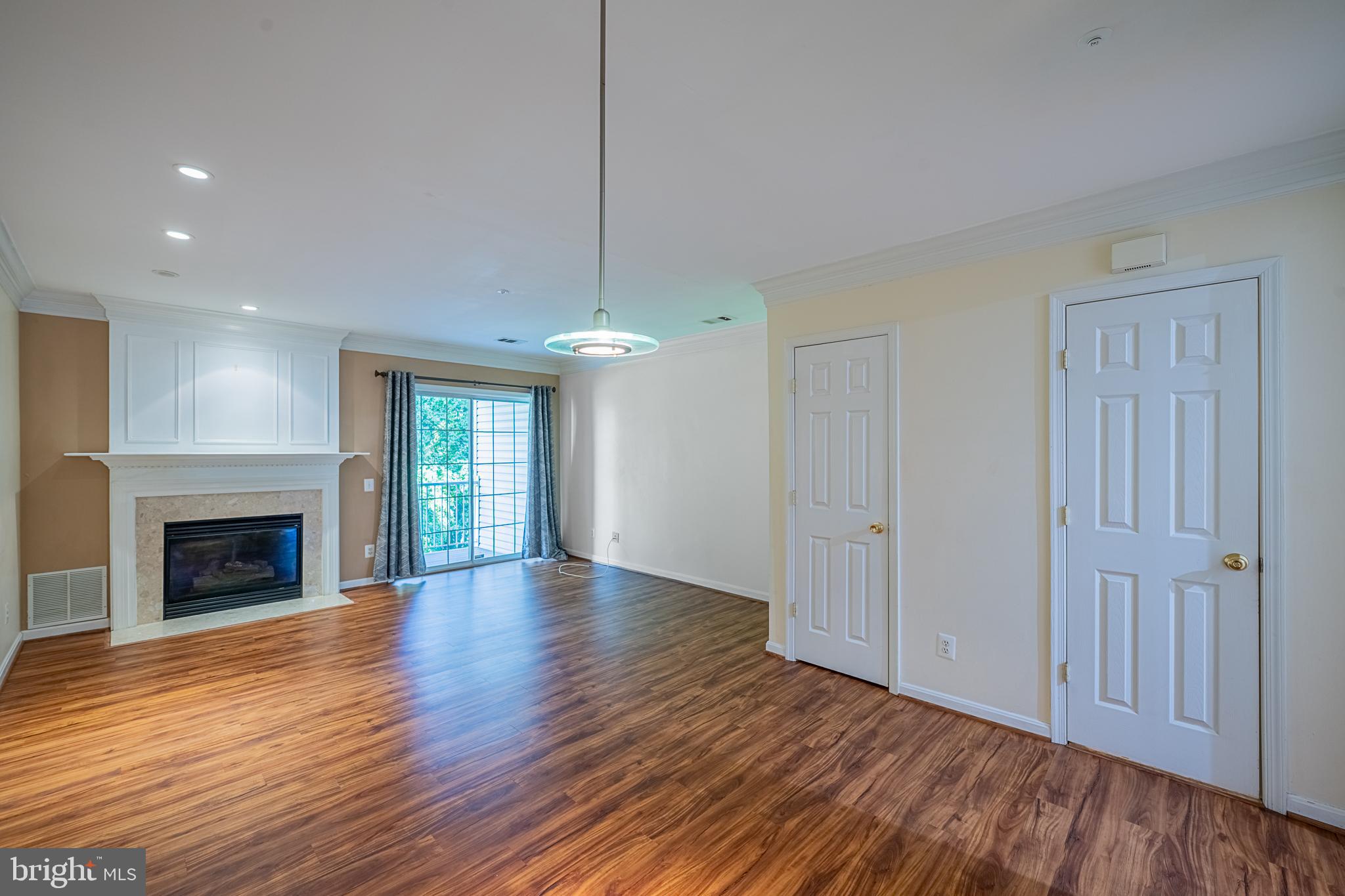 5920 Terrapin Place Alexandria, VA 22310 - Photo 19 of 67 a view of an empty room with wooden floor fireplace and a window