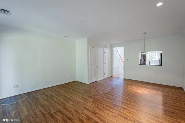 a view of a balcony with a floor to ceiling window and wooden floor