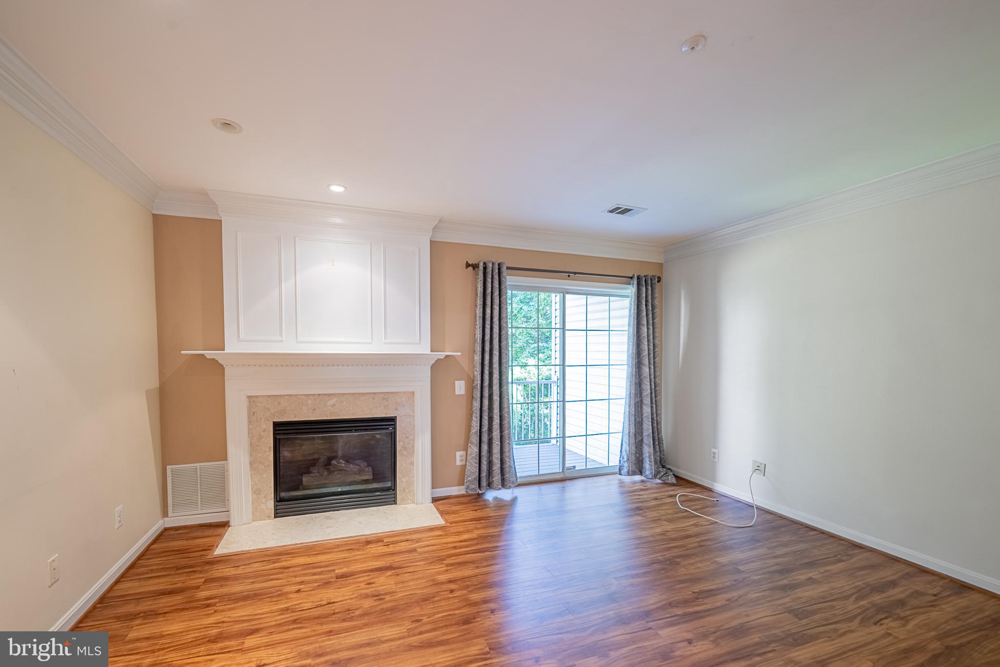 5920 Terrapin Place Alexandria, VA 22310 - Photo 23 of 67 an empty room with wooden floor fireplace and windows