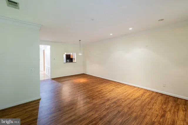 a view of a room with wooden floor and iron stairs