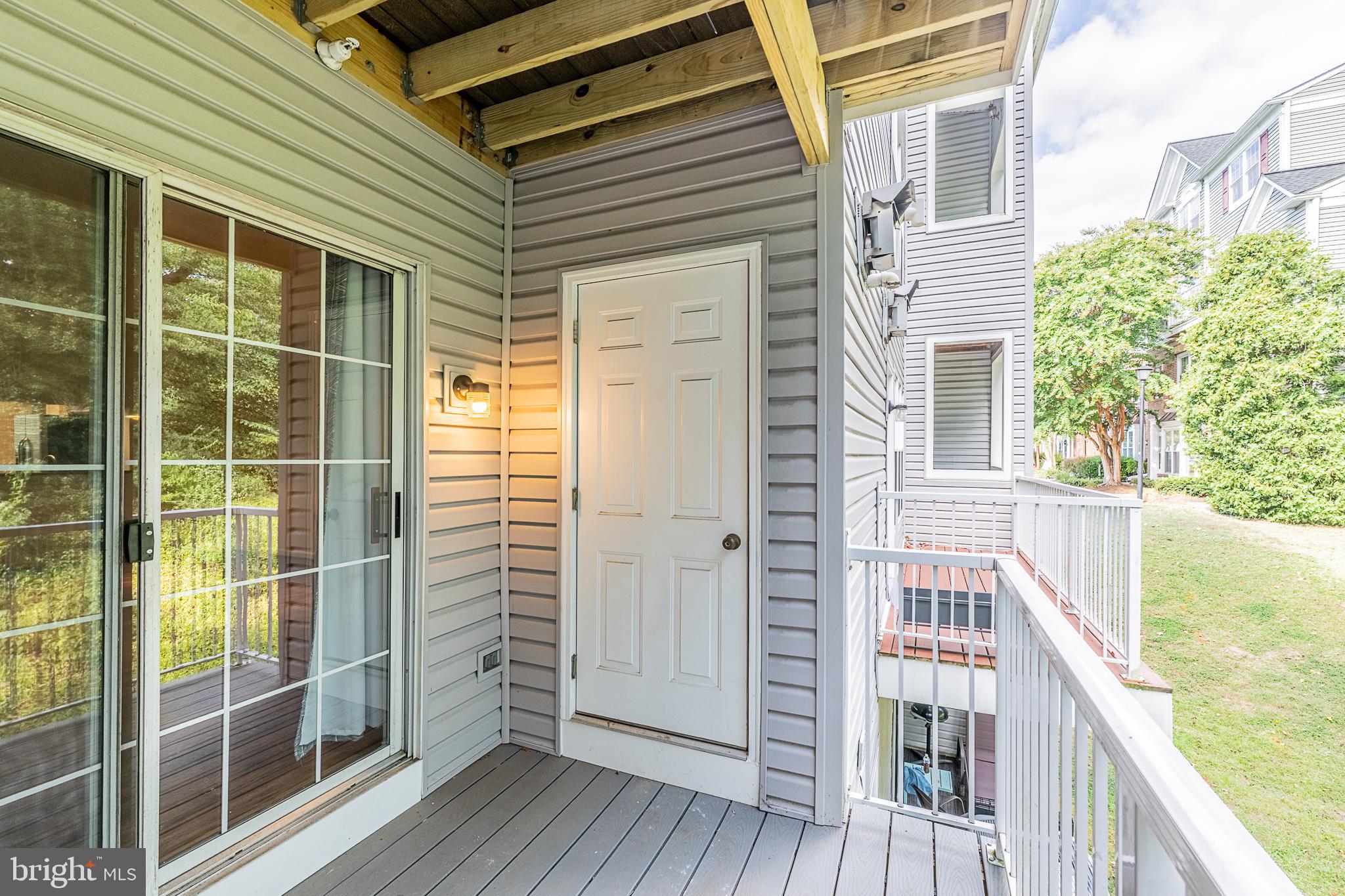 5920 Terrapin Place Alexandria, VA 22310 - Photo 26 of 67 a view of a balcony with a floor to ceiling window and wooden floor
