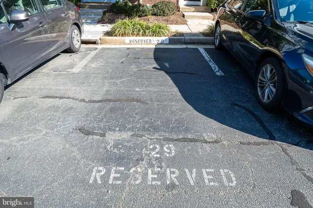 a view of staircase with railing and white walls