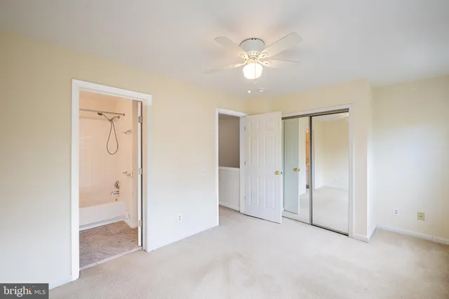 a bathroom with a sink shower and a mirror
